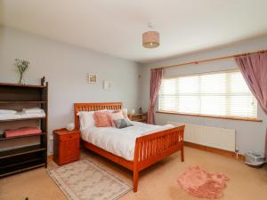 a bedroom with a bed and a window at Hook Head Hideaway 