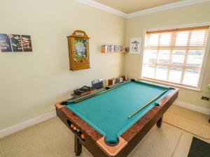 a room with a pool table and a clock at Tighe Carra in Ballygarries