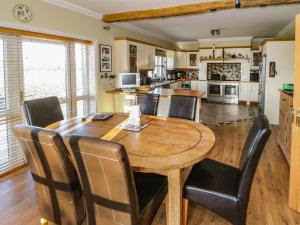a kitchen and dining room with a wooden table and chairs at Tighe Carra in Ballygarries
