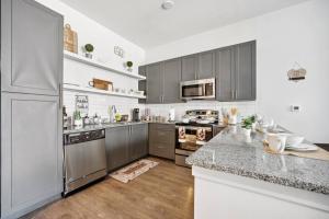a kitchen with stainless steel appliances and a counter top at Luxurious 1BD apt in Austin suburb in Pflugerville