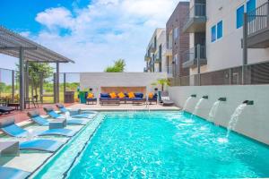 a swimming pool with lounge chairs and a swimming pool at Luxurious 1BD apt in Austin suburb in Pflugerville