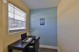 an office with a desk with a laptop on it at Gorgeous Beach Condo in St. Petersburg