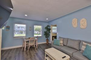 a living room with a couch and a table at Gorgeous Beach Condo in St Petersburg