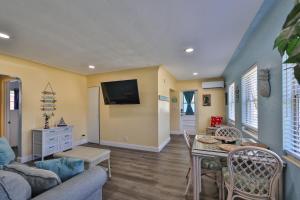 a living room with a couch and a table at Gorgeous Beach Condo in St Petersburg