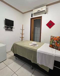 a hospital room with a bed and a tv at Pousada do Marinho in Búzios