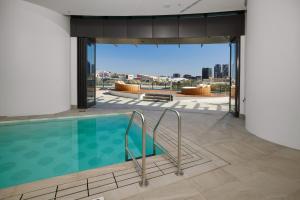 a swimming pool in a building with a view of the city at Riverfront Panorama with 2 Kings, Fireworks & Parking in Brisbane