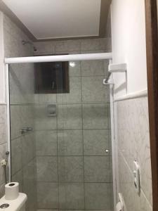 a bathroom with a glass shower with a toilet at Pousada do Marinho in Búzios