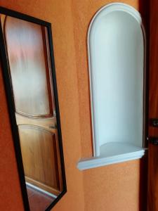 a mirror next to a door with a window at Mountain View Lofts Guayabitos in Rincon de Guayabitos