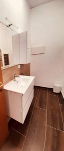 a bathroom with a white sink and a toilet at Maura's b&b in Gallarate
