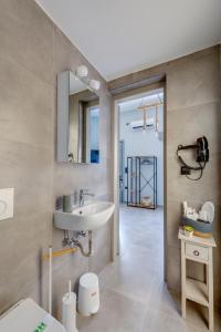 a bathroom with a sink and a mirror at LUNA & TERRA APARTMENTS SYROS in Ermoupoli
