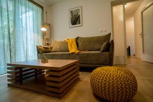 a living room with a couch and a coffee table at Apartman Terra centar, free parking in Osijek