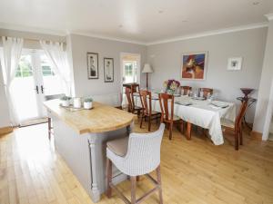 a kitchen and dining room with a table and chairs at The White House in Drumshanbo