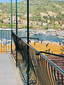 a balcony with a view of a harbor with boats at Casa Racchia in Porto Santo Stefano