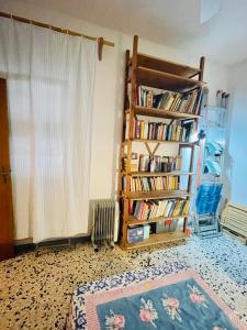 a room with a book shelf filled with books at Casa Racchia in Porto Santo Stefano