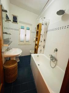 a bathroom with a tub and a sink and a toilet at Casa Racchia in Porto Santo Stefano +10 photos