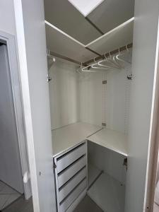 a walk in closet with white cabinets and a ceiling at Monolocale Portoverde Beach in Misano Adriatico +13 photos