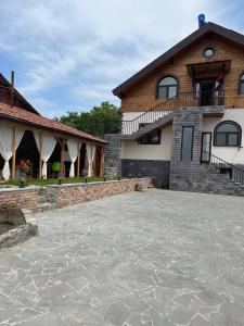 a house with a stone driveway in front of it at NOY Guest House B&B in Vanadzor