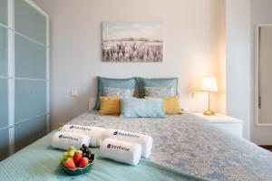 a bedroom with a bed with fruit on it at Cozy Sunny Flat w/ Terrace - São João in Porto