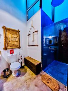 a bathroom with a white toilet and a shower at Pousada Roots - D3 Experience - Préa, CE in Prea