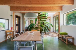 a room with a table and chairs and a spiral staircase at Domaine La Ferme HI bride in Villelaure