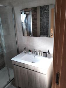 a bathroom with a white sink and a shower at Relaxing Beach Paradise in Carvoeiro