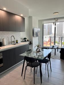 a kitchen with a table and chairs in a kitchen at Brand NEW modern 1 bedroom unit Downtown in Miami