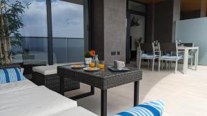 a living room with a table with food on it at SUNSET WAVES sea view apartments in Benidorm