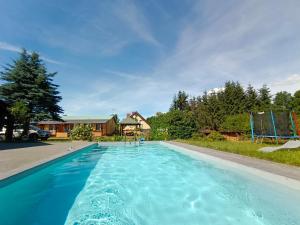 a large swimming pool with blue water at Agroturystyka Alex in Szczecinek