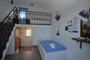 a small room with a bed and a staircase at Nefeli Apartments in Kefalos +41 photos