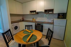 a kitchen with a wooden table with bats on it at Apartman Terra centar, free parking in Osijek