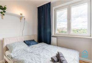 a bedroom with a bed and a window at Bigly Room in Gdańsk