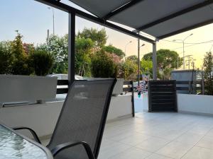 a patio with a table and chairs on a roof at K.G APARTMENT 2 in Pefkohori