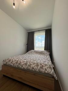 Кровать или кровати в номере Apartament 1410