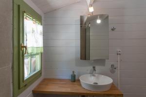 a bathroom with a sink and a mirror at metaxaki cottage in Mikros Gialos