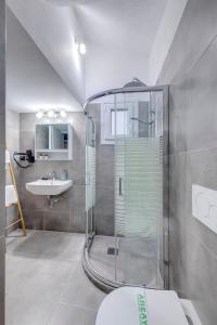 a bathroom with a shower and a toilet and a sink at LUNA & TERRA APARTMENTS SYROS in Ermoupoli +39 photos