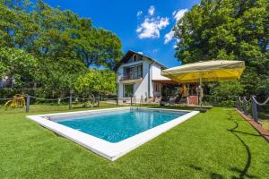 a swimming pool in the yard of a house at PLAVAC in Kostelj