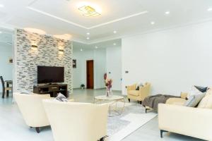 a living room with white furniture and a fireplace at Y-twin apartments in Yaoundé