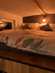a bedroom with a large bed with a white blanket at Tiny house Malý gurmán 
