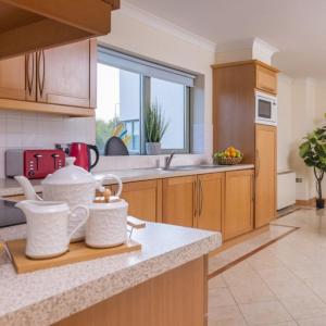 a kitchen with wooden cabinets and a counter top at Park Place Apartments in Killarney