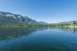a view of a lake with mountains in the background at All About the Lake by NW Comfy Cabins in Leavenworth