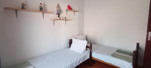 a bedroom with two beds and shelves on the wall at Julija Guest House in Ohrid