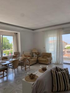 a living room with a couch and a table and chairs at la PADINI CASA sul mare in Neoi Epivates