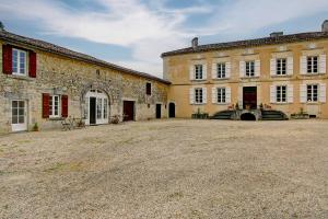 an old building with a large yard in front of it at La Maronniere in Challignac