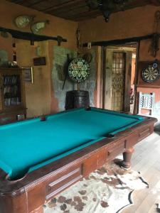 a green pool table in a room with a wall at La Antigua Hotel de Montaña in Quito