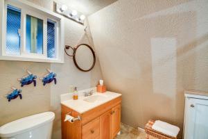 a bathroom with a sink and a toilet and a mirror at Charming Grayland Getaway Walk to the Beach! in Grayland +16 photos