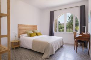 a bedroom with a bed and a desk and a window at Torre Chiguita in Tarazona de Aragón +55 photos