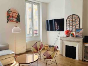 a living room with a couch and chairs and a fireplace at Pleasant 3-bedroom flat in the center of Marseille in Marseille
