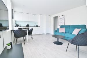 a living room with a blue couch and a table at G7 Akureyri Central Apartments in Akureyri