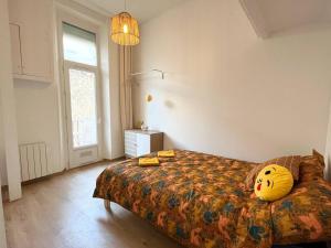 a bedroom with a bed with a pillow on it at Pleasant 3-bedroom flat in the center of Marseille in Marseille