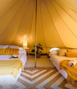 a bedroom with two beds in a tent at Slow Axarquía in Torre de Benagalbón